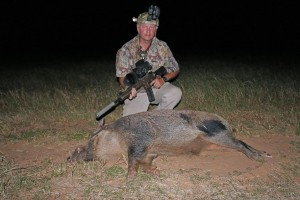 The author with a nice 305 pound boar taken after an afternoon dove hunt.